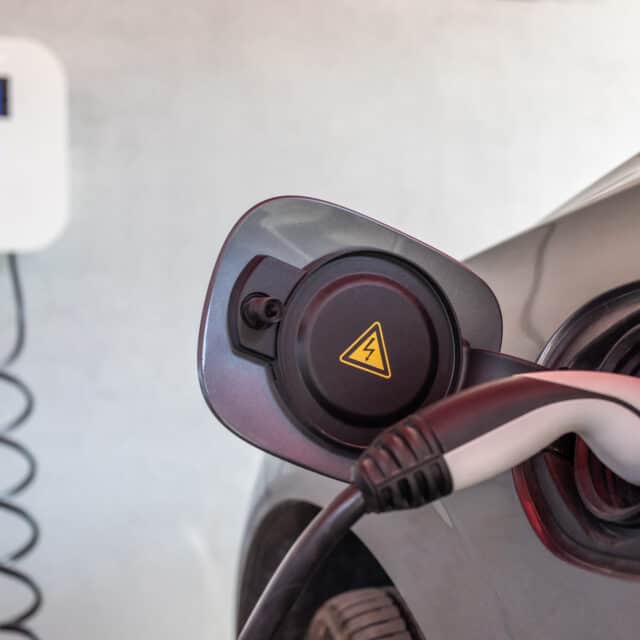 EV charger plugged into electric car.