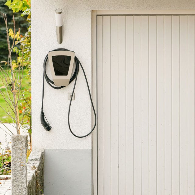 Legrand EV plugged into the wall of a house to charge an electric car.